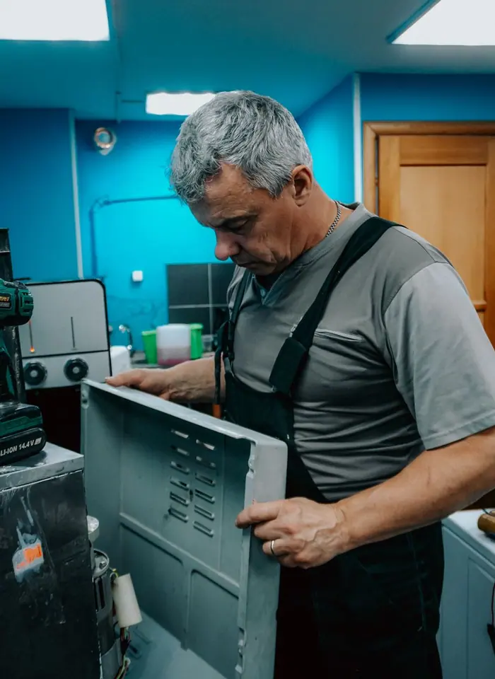 Repair technician examining an appliance