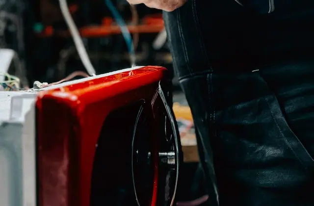 Technician repairing a microwave