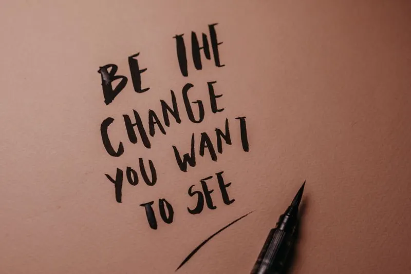 Motivational quote written in calligraphy on a pink surface
