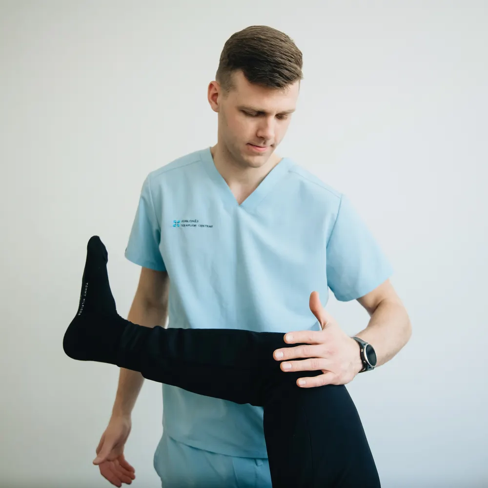 Physiotherapist treating a patient's knee pain