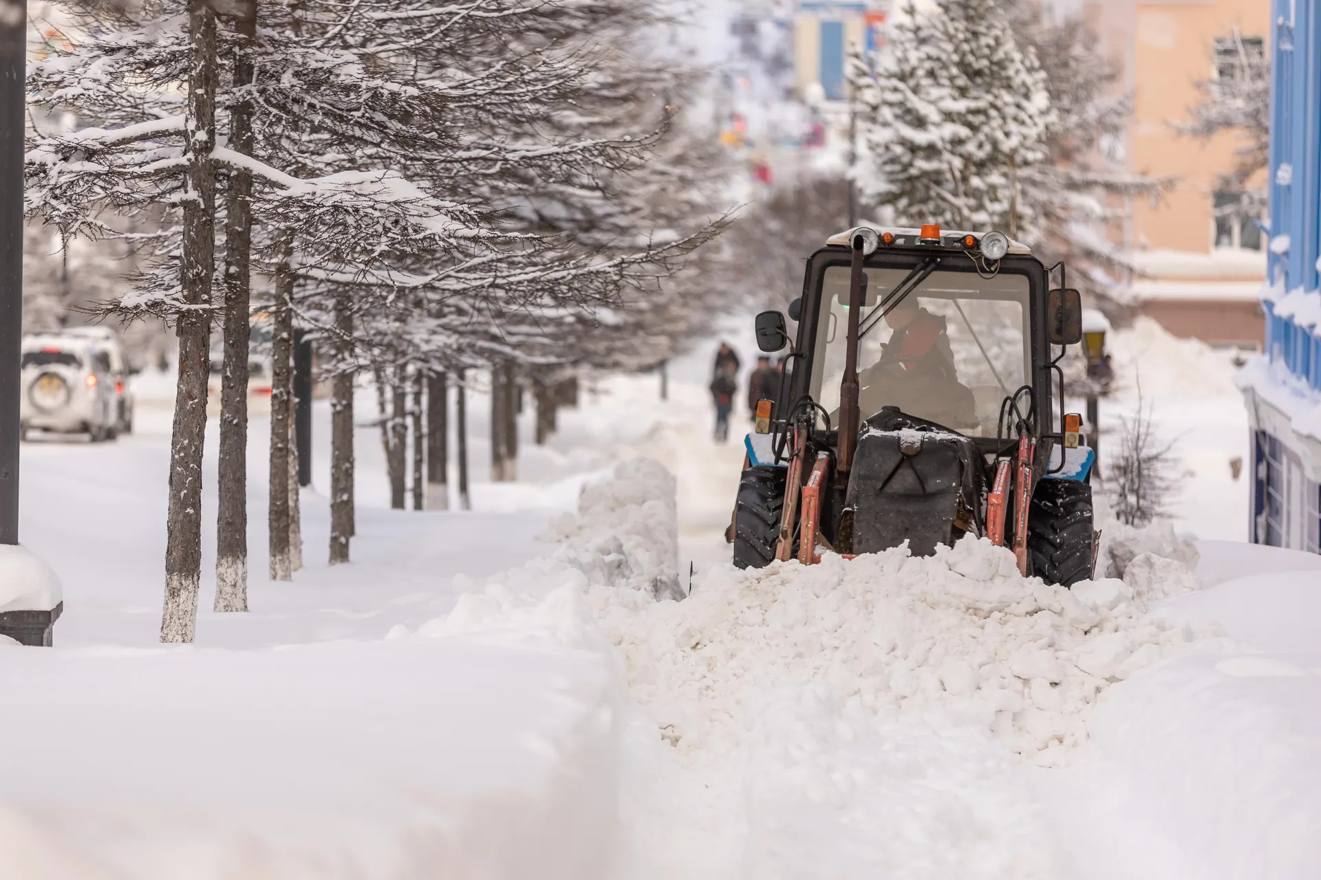 Snow plow truck clearing a city street