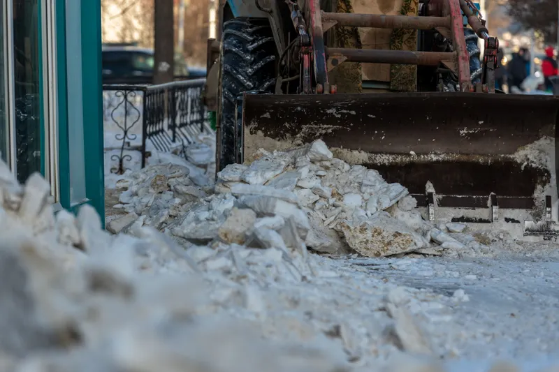 Plow clearing an urban street