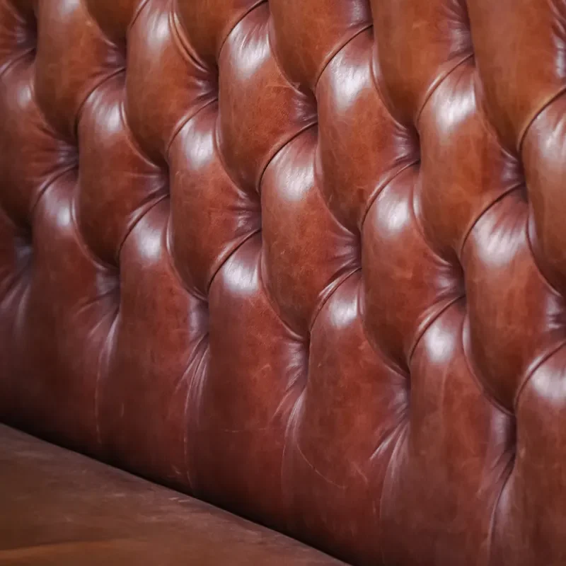 Tufted brown leather couch in close-up