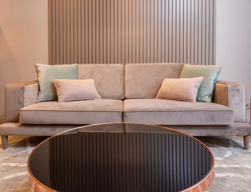 Couch with soft pillows and a round coffee table