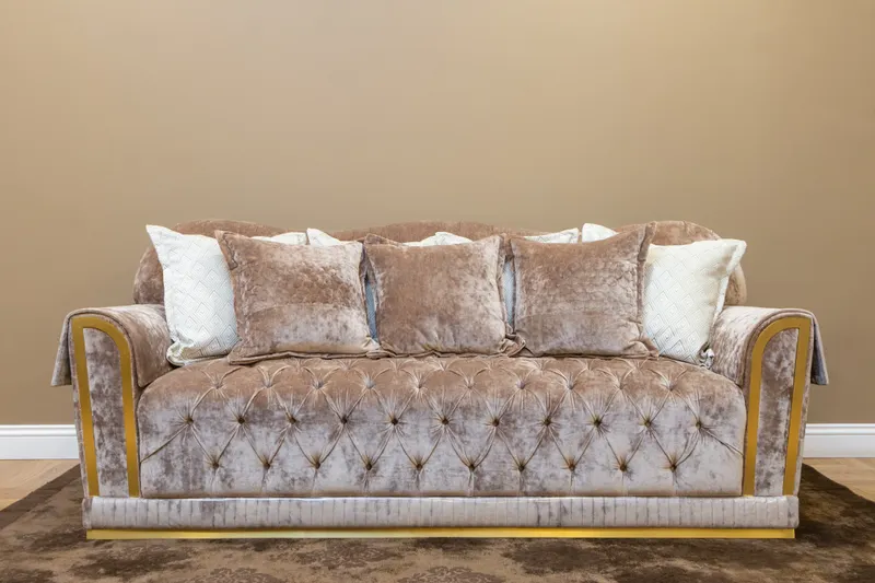 Beige three-seat sofa with plush cushions